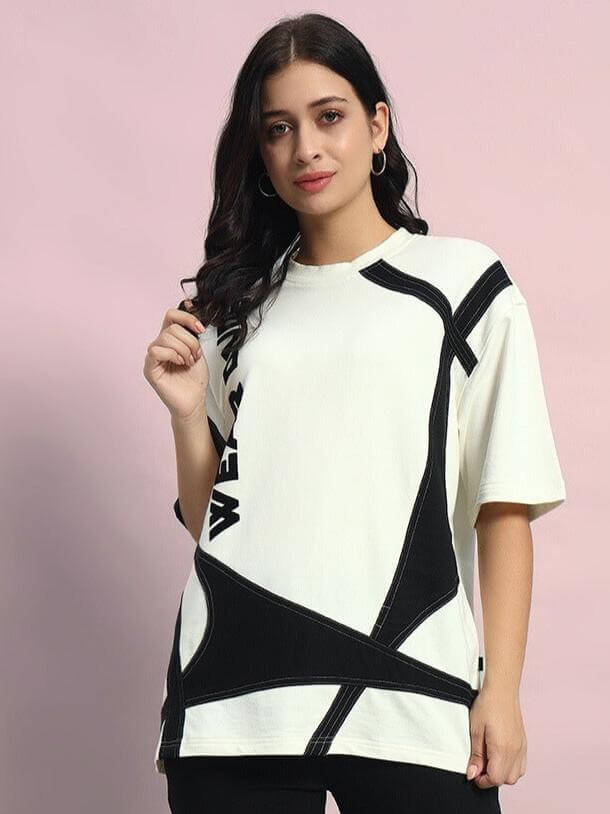 Model wearing oversized women's designer T-shirt in off white with black accents, crafted from premium French Terry Lycra, front view.