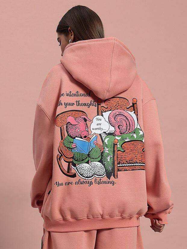 Women's deliberate fleece hoodie in peach with artistic back print, featuring a cozy design for style and comfort.