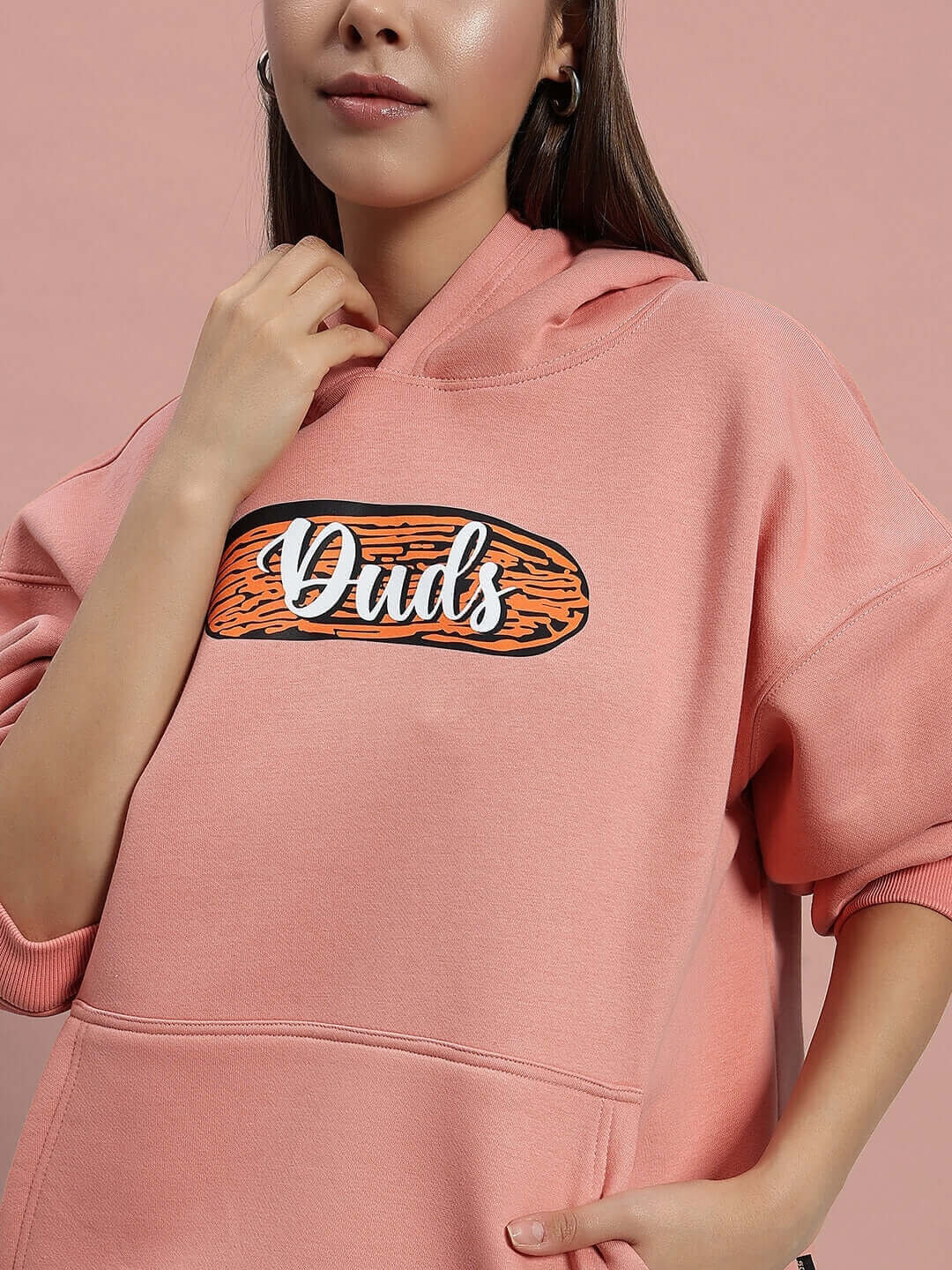 Women's deliberate peach fleece hoodie with logo, casual style, comfortable fit, perfect for cool weather fashion.