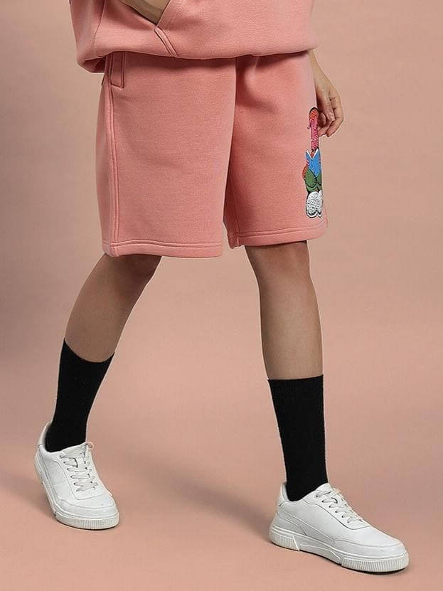 Woman wearing WOMEN DELIBERATE FLEECE SHORTS PEACH, showcasing comfort and style with premium-quality fleece fabric.