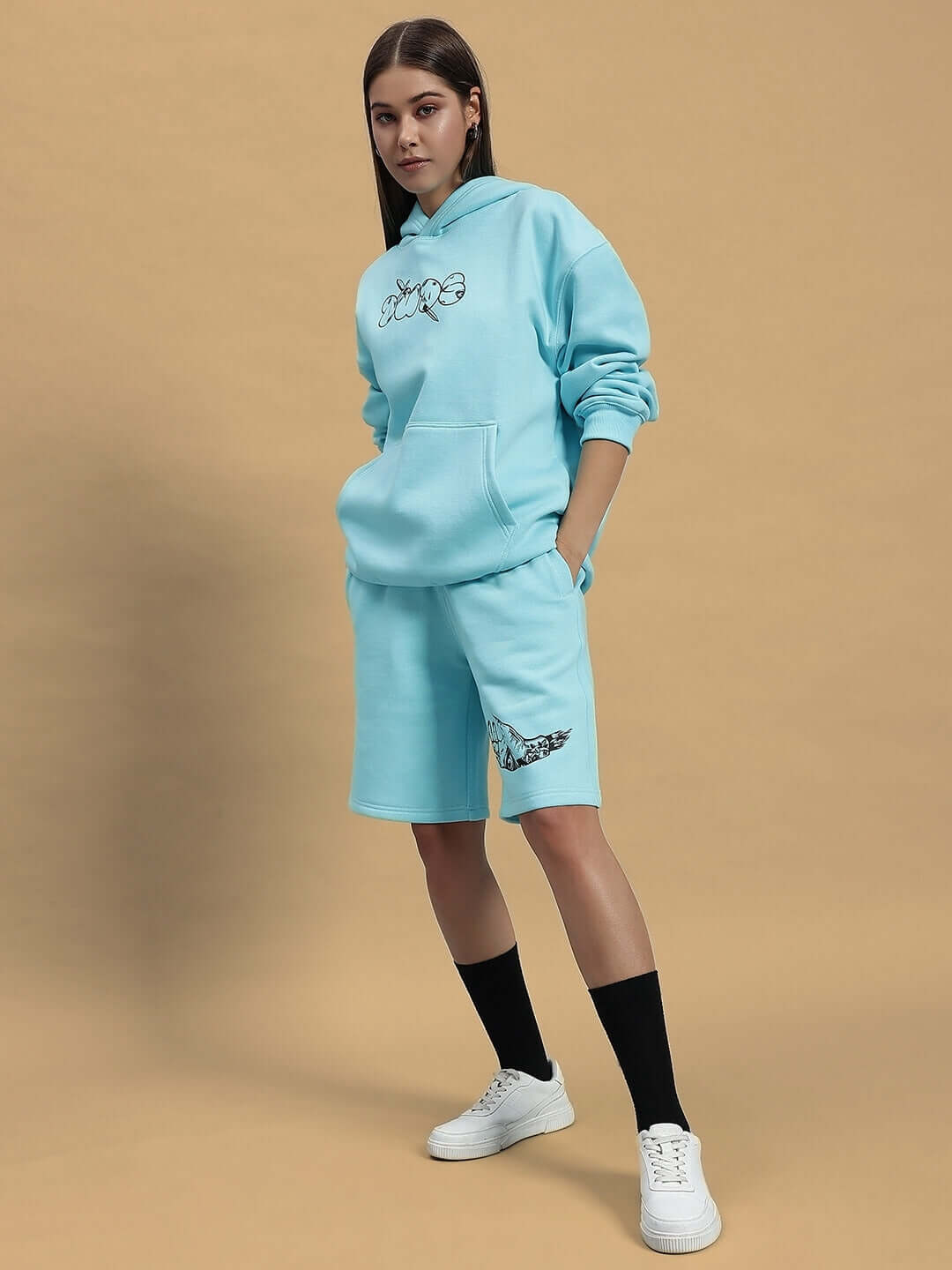Model wearing WOMEN DEMON FLEECE CO-ORD SKY BLUE, featuring hoodie and shorts set with custom sizing option, standing in studio setting.