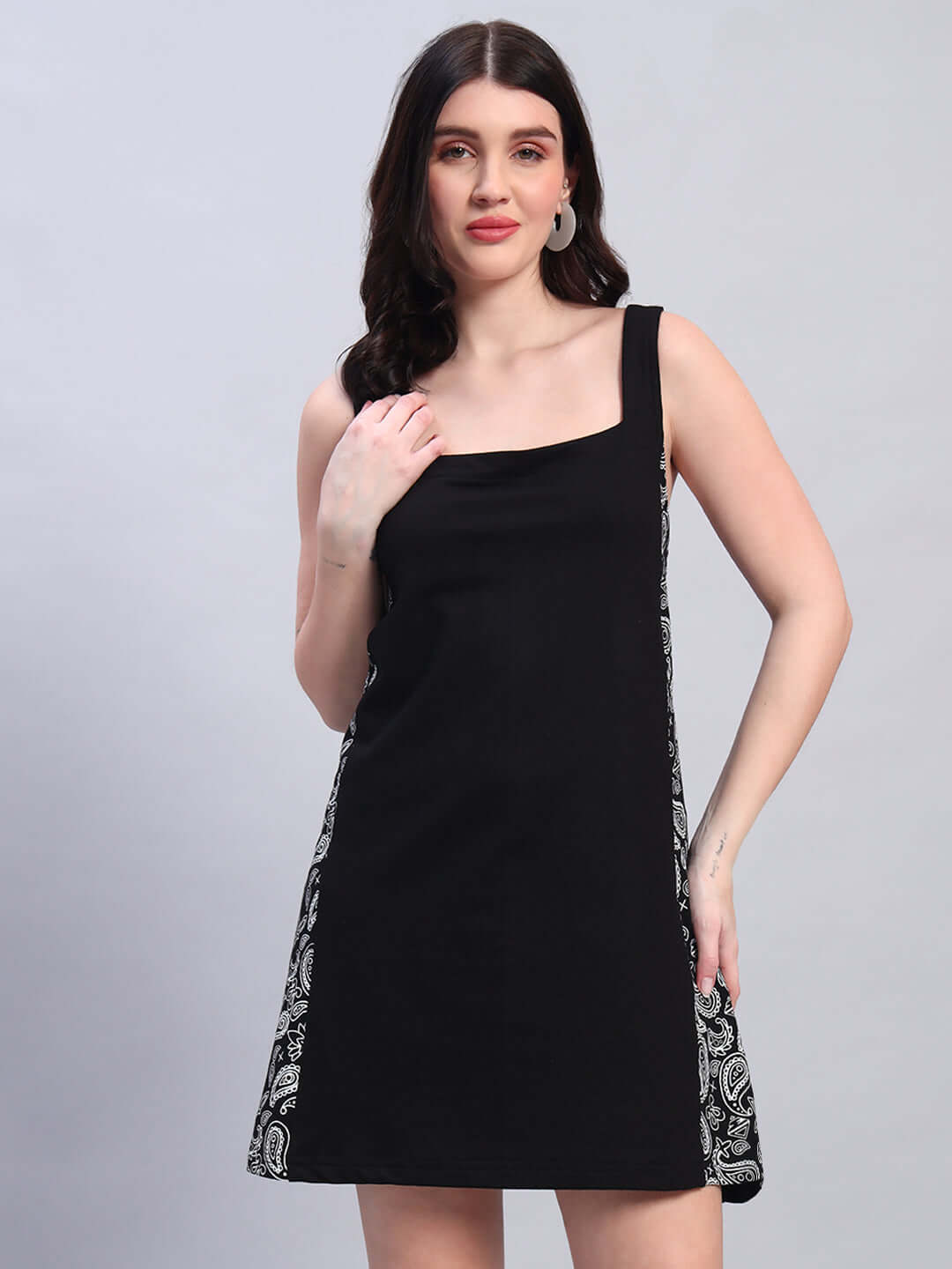 Woman wearing Women's Kudos Dress in black, featuring four-way Lycra fabric with paisley sides, highlighting elegant sleeveless design.
