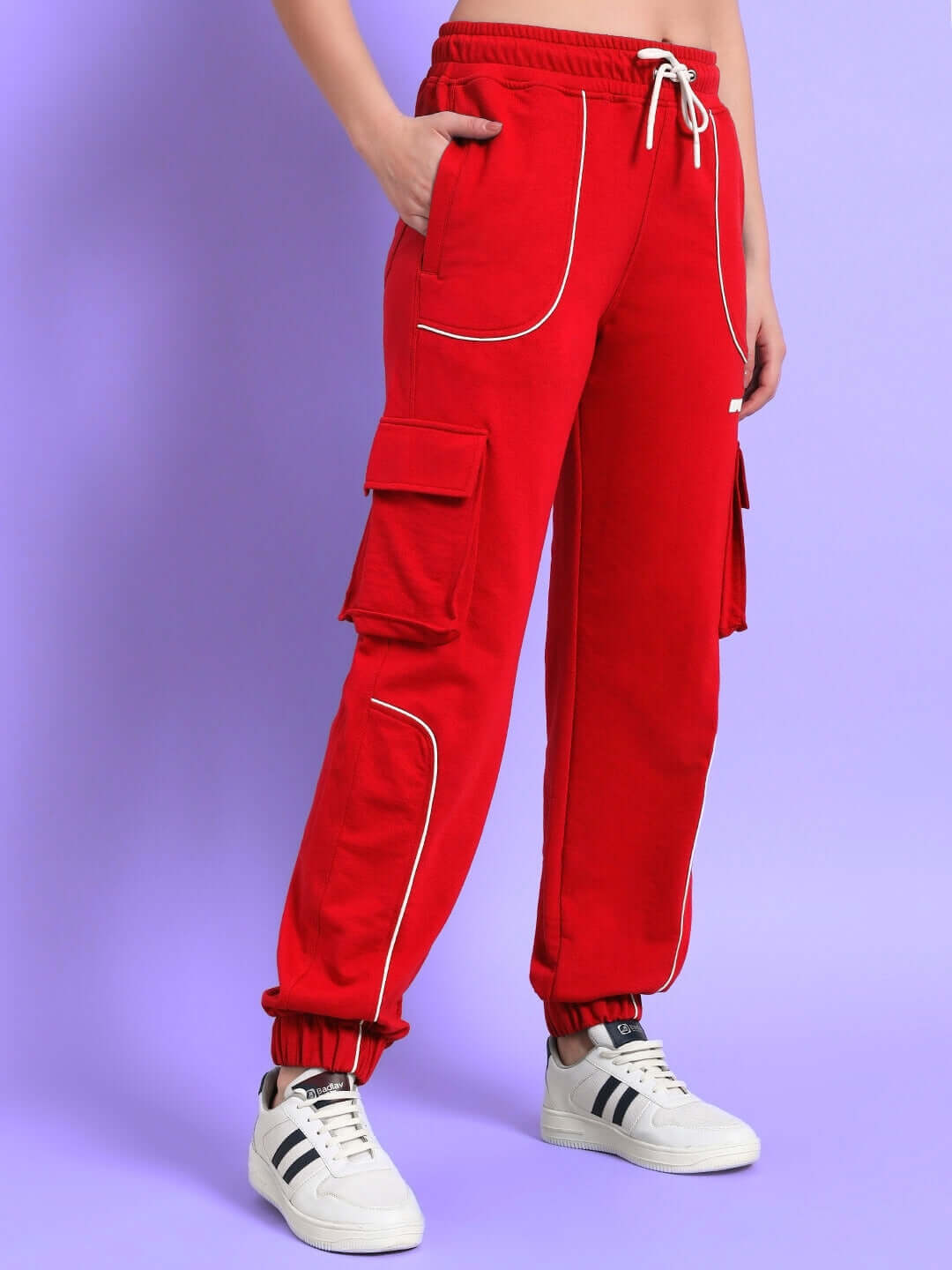 Woman wearing red Deveno relaxed-fit joggers with cargo pockets, drawstring waist, paired with white sneakers.