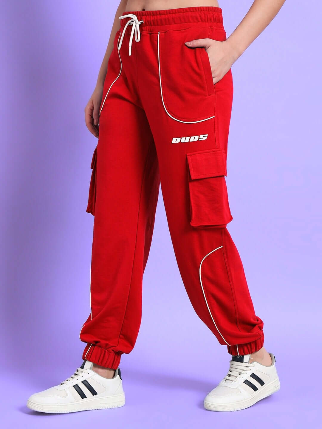 Red women's DUDS Devono relaxed-fit joggers with pockets, worn by model. Perfect for custom fit and pre-paid orders. Comfortable fabric.