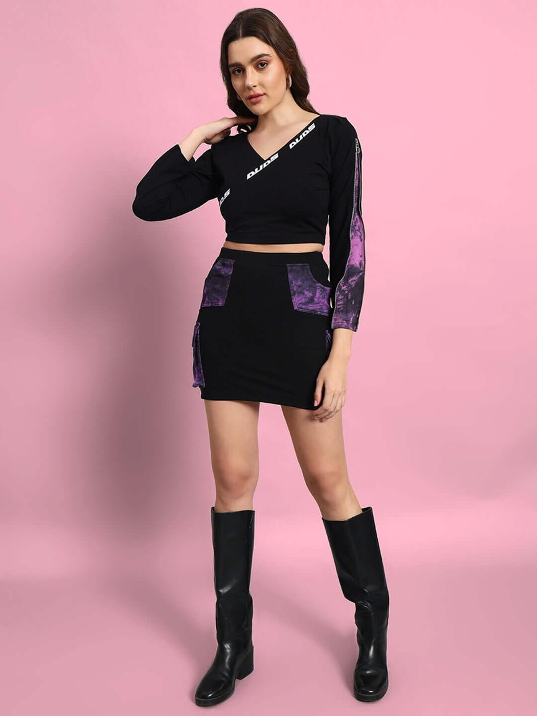 Model wearing Women's Diana Co-Ord Set in black-purple, featuring premium cotton French terry and elastane, styled with black boots.