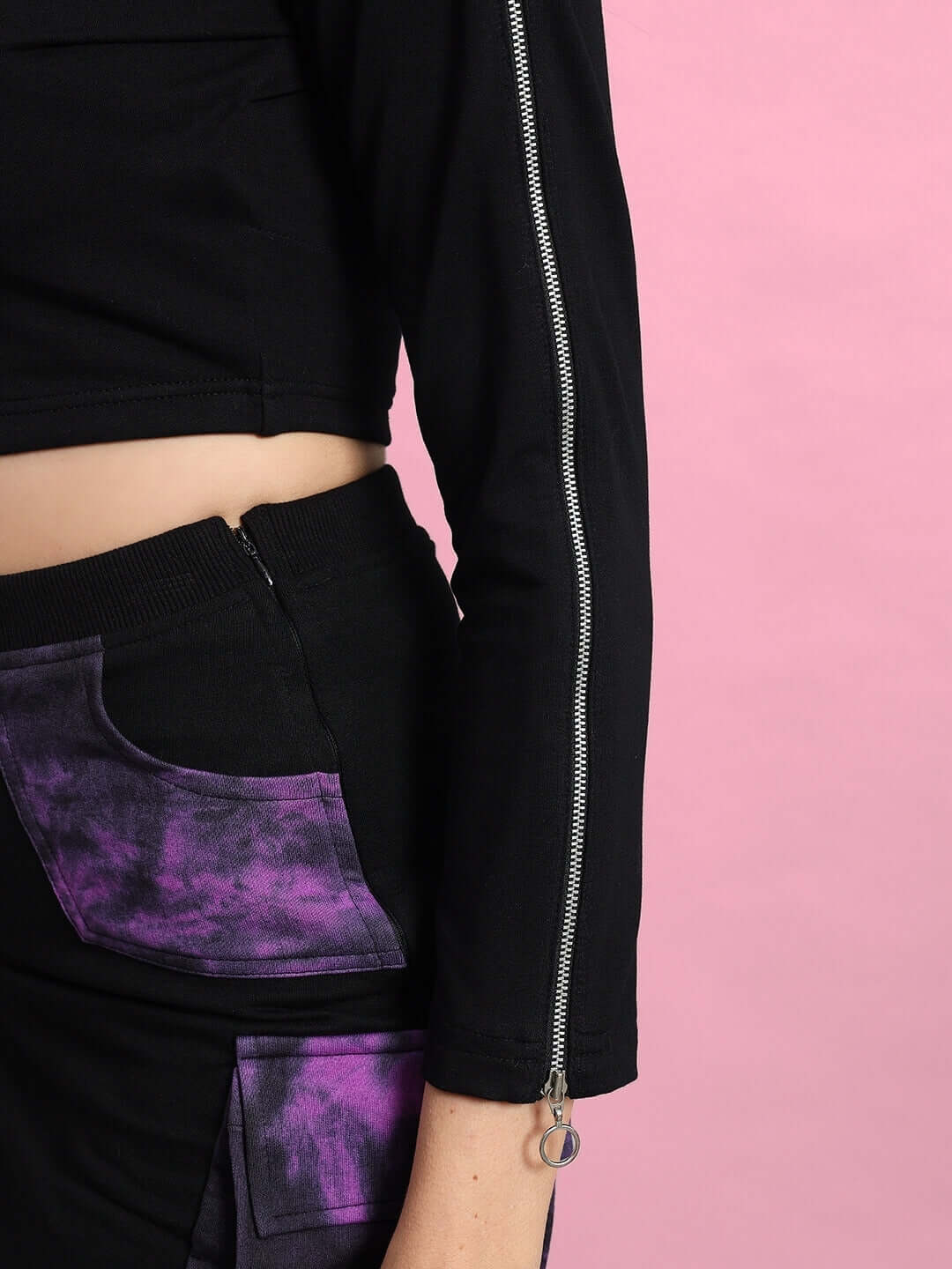Close-up of black and purple women's Diana co-ord set featuring a zip detail and tie-dye pocket, made with premium cotton fabric.