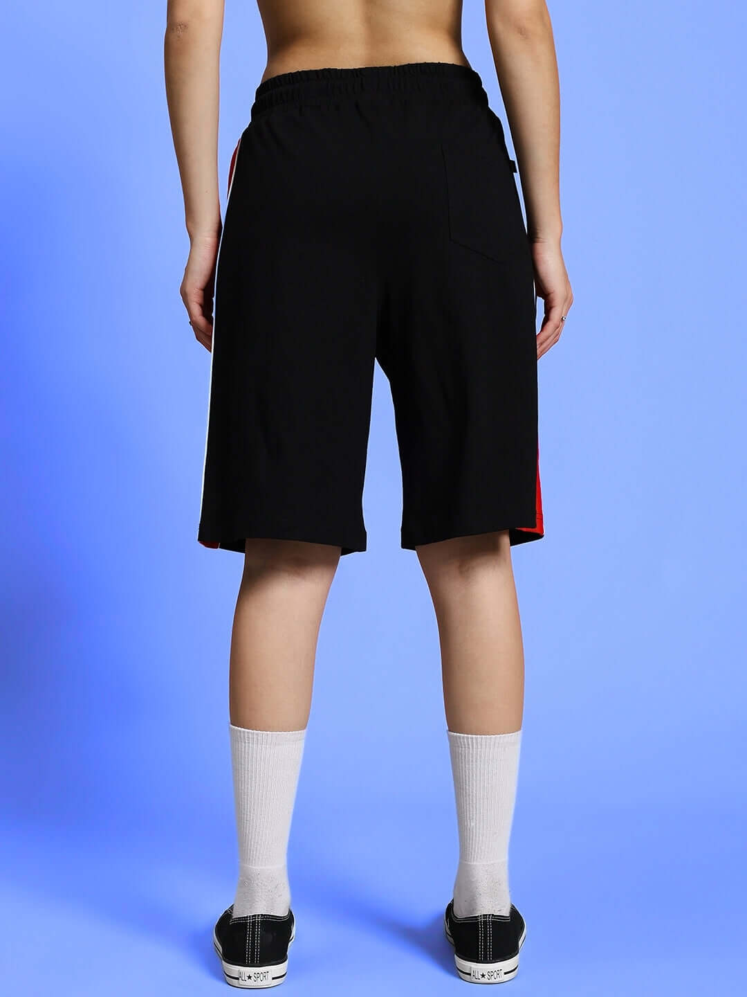 Back view of black WOMEN'S DRIFT REGULAR FIT SHORTS, showcasing relaxed fit and knee-length design.