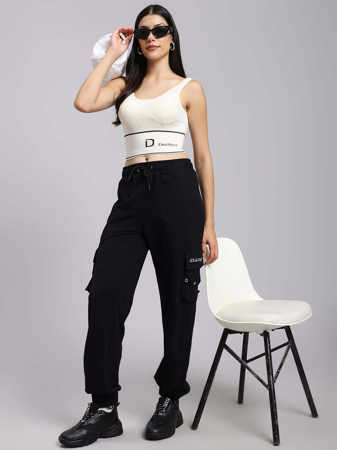 Model wearing Women's DUDS Commando Joggers in black; stylish and customizable, ideal for relaxed or sporty settings.