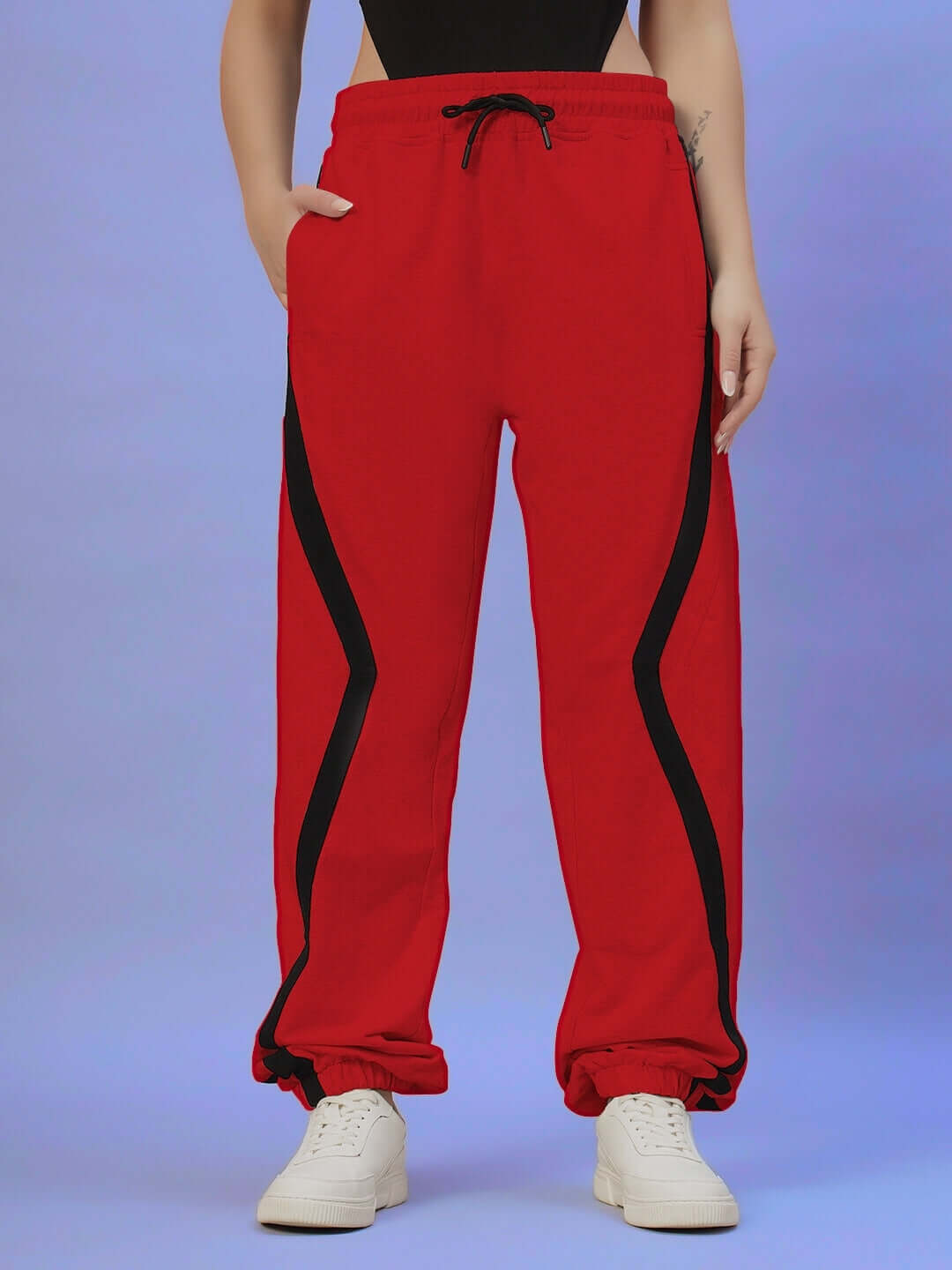 Women's DUDS Red Frame Joggers with black stripe accents, worn with white sneakers, featuring adjustable drawstring waist.
