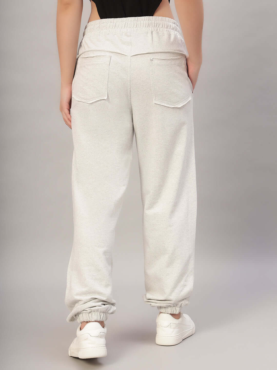 Back view of Women's DUDS Graze Joggers in Melange Grey, showcasing elastic waistband and pockets, highlighting stylish comfort.