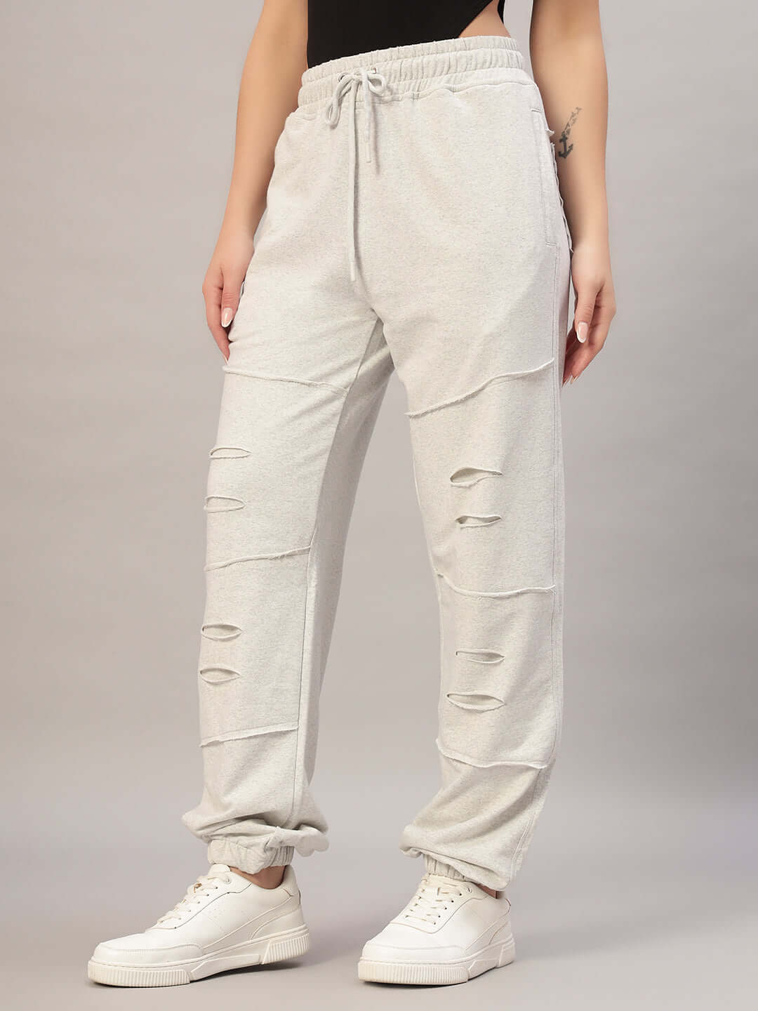 Model wearing Women's DUDS Graze Joggers in Melange Grey, featuring custom fit options and made-to-order tailoring by DUDS.