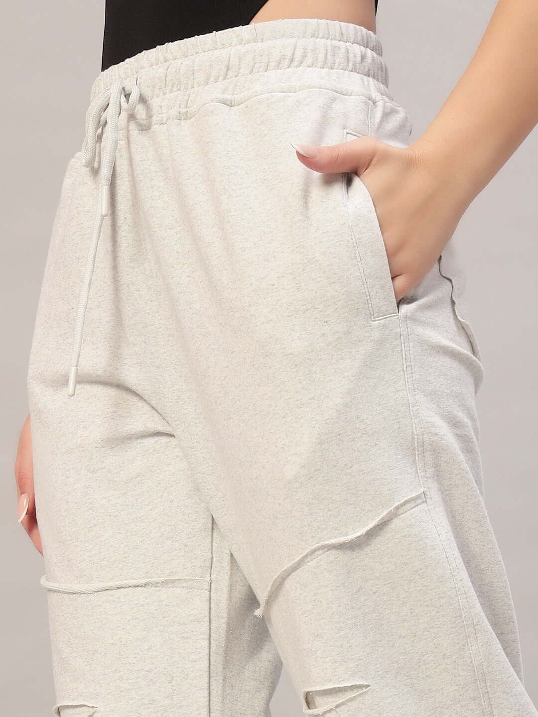 Model wearing Women's DUDS Graze Joggers in melange grey with custom fit option, showcasing soft fabric and pocket details.