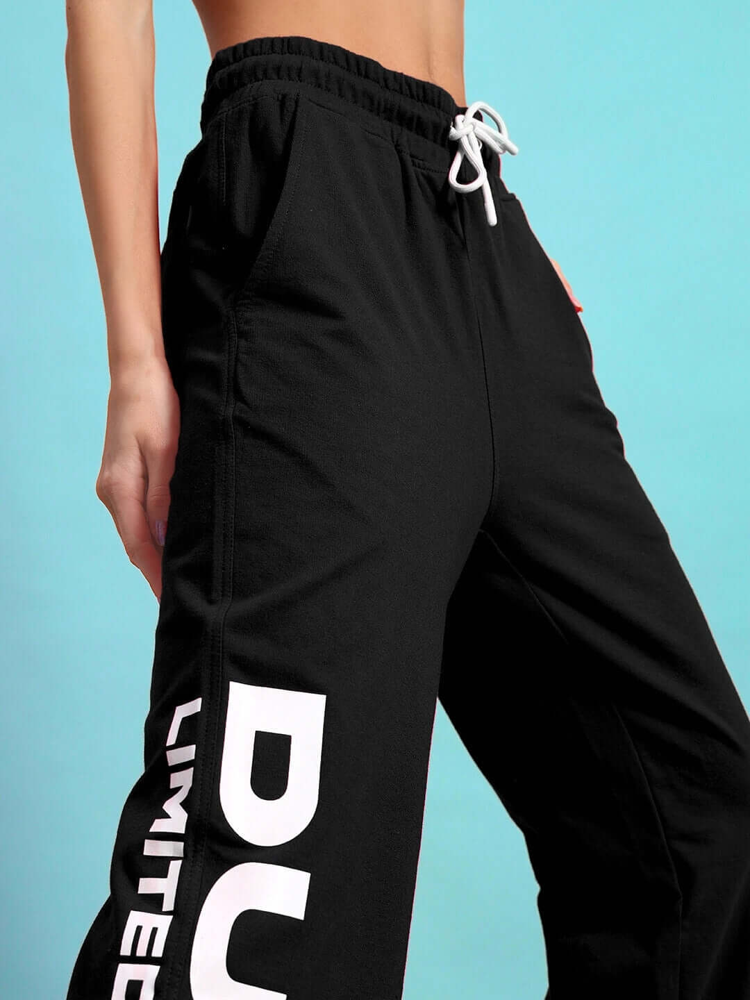 Close-up of Women's DUDS Limited Edition Jogger in black, featuring elastic waistband and bold white lettering on soft fabric.