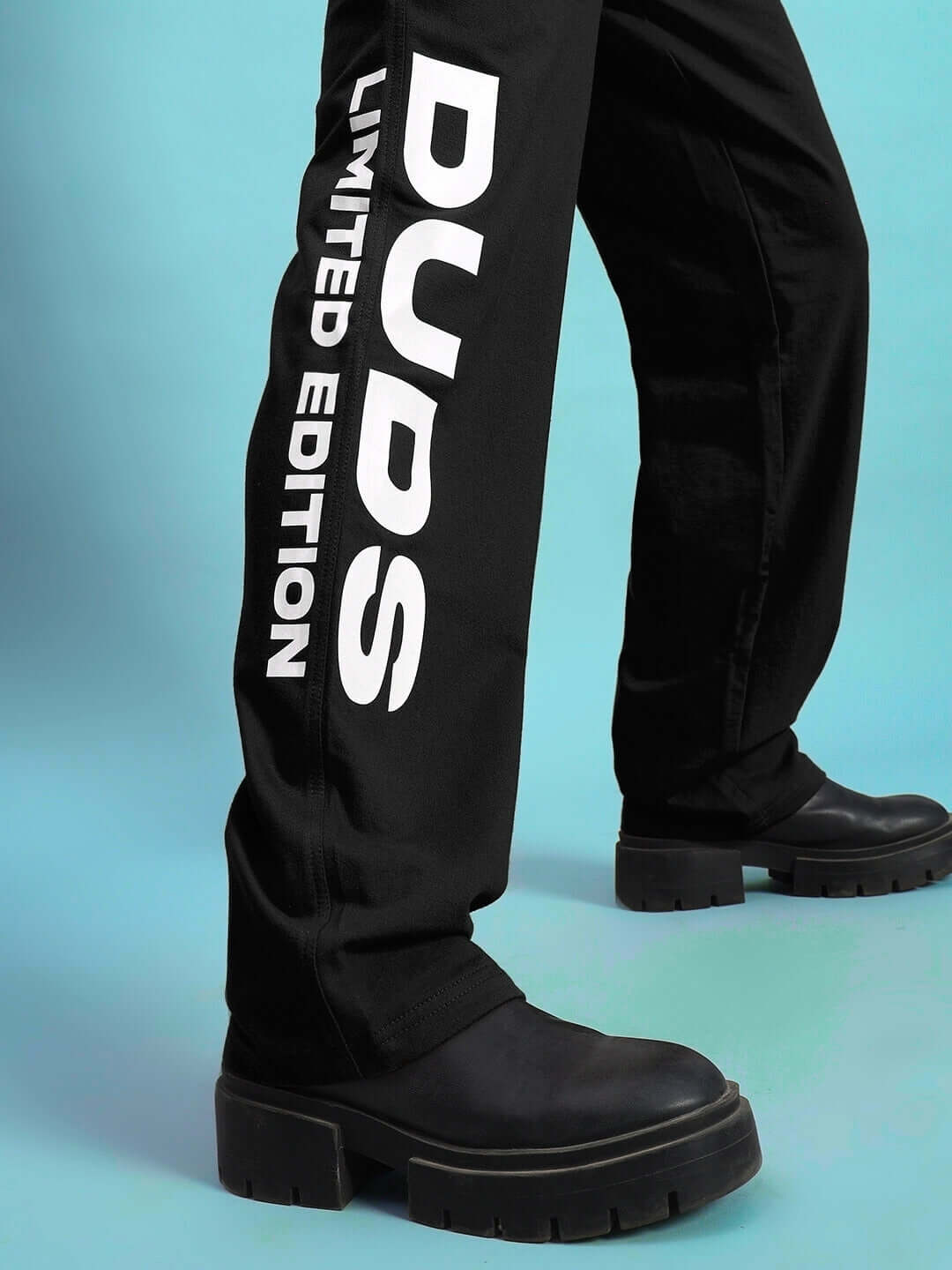 Model wearing Women's DUDS Limited Edition Jogger in black with bold branding on pant leg.