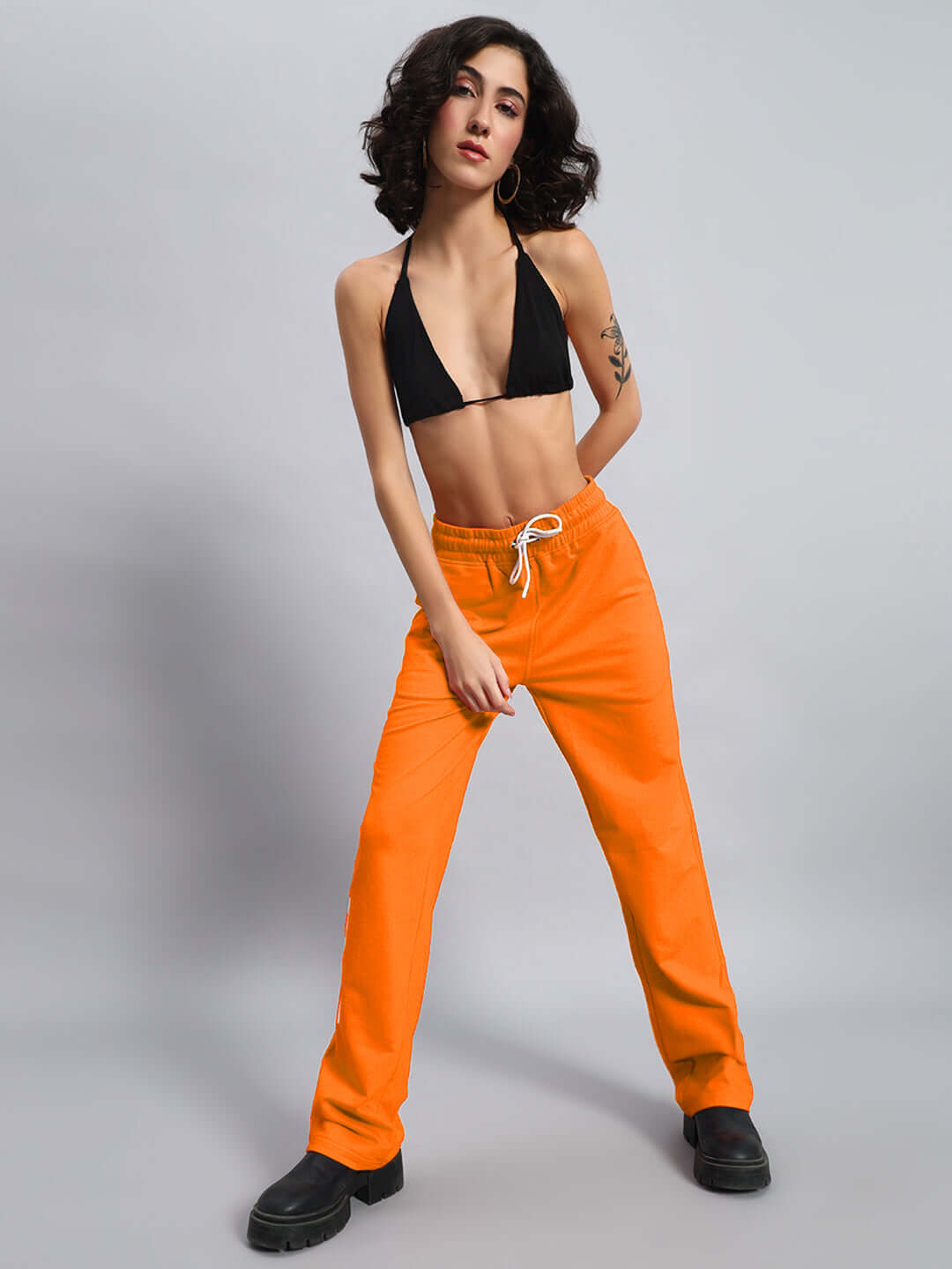 Woman wearing Women's DUDS Limited Edition Jogger Orange, stylish and comfortable, made by experienced tailors, customizable fit available.