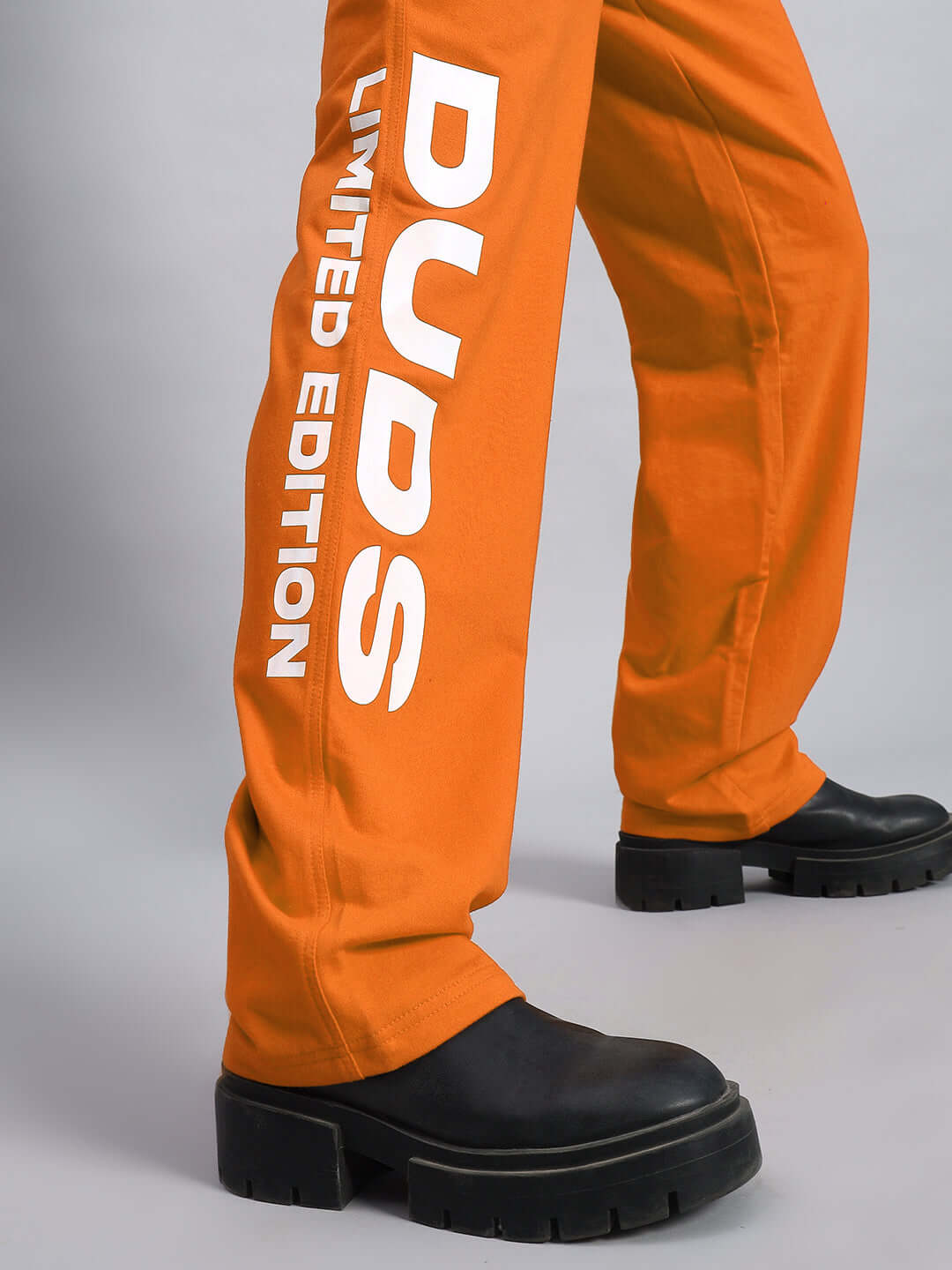 WOMEN'S DUDS LIMITED EDITION JOGGER ORANGE with bold lettering and black shoes