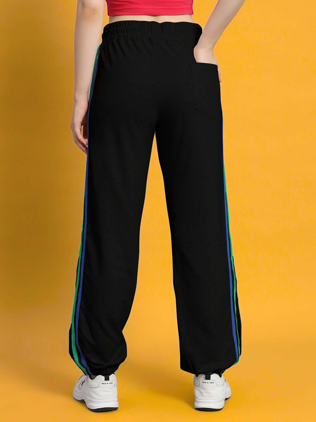 Back view of women's DUDS black joggers with colorful stripes, showcasing relaxed fit and style.