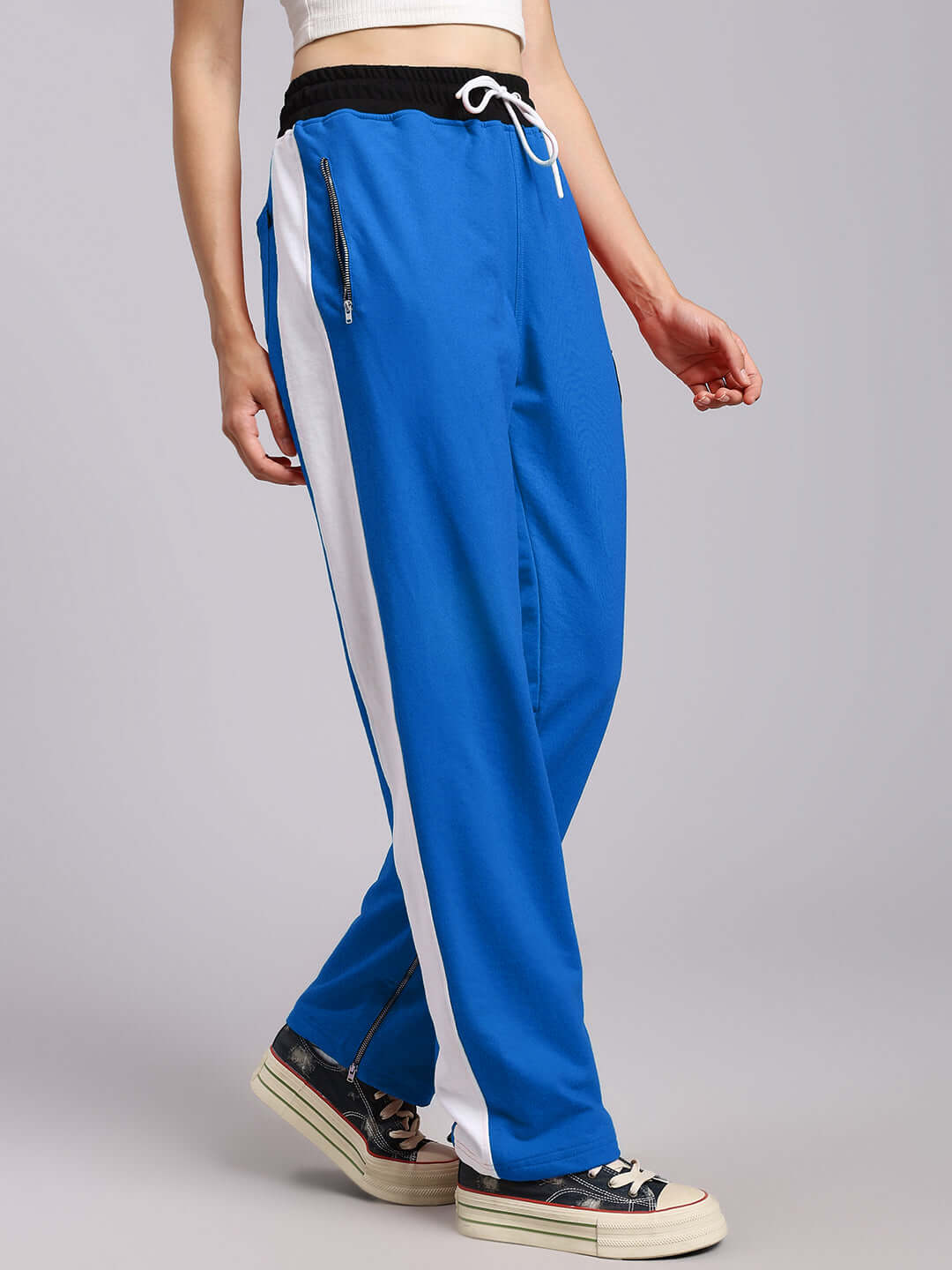 Model wearing WOMENS ELEGANT RELAXED-FIT JOGGERS BLUE showcasing side stripe and ankle detail.