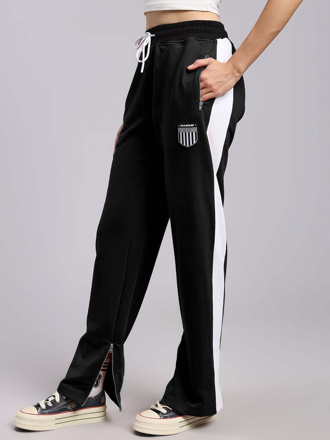 Women's elegant relaxed-fit black joggers with white side stripes and adjustable drawstring for a custom fit.