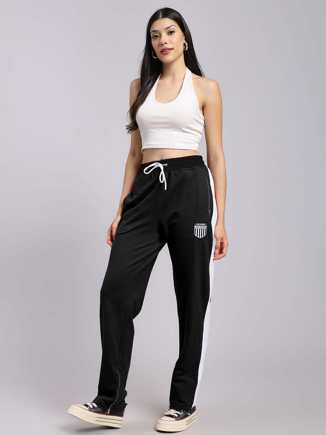 Model wearing women's elegant relaxed-fit black joggers, featuring a comfortable custom fit option by DUDS, displayed on a grey background.