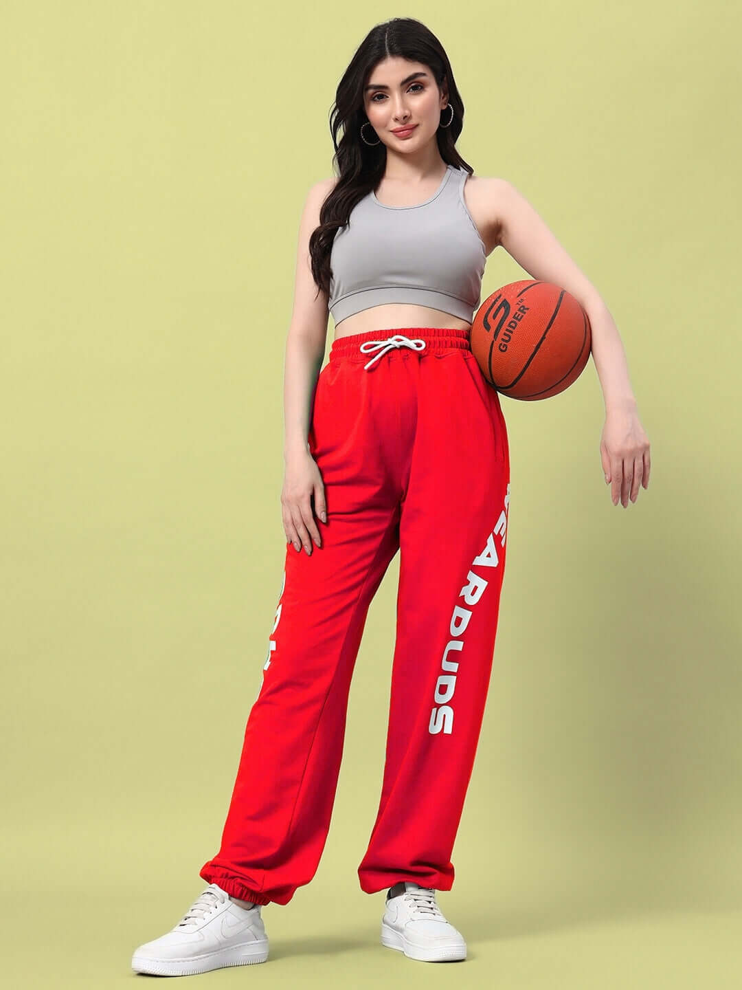 Woman wearing WOMEN'S ELLEN RELAXED FIT JOGGER RED holding a basketball.