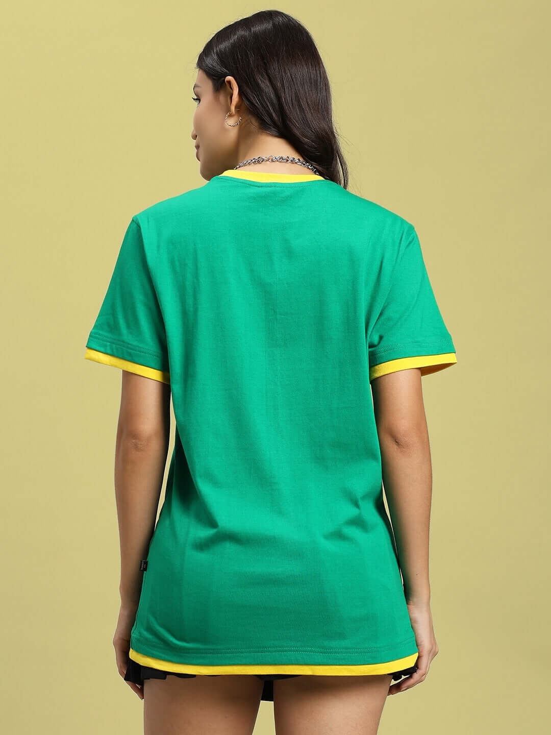 Back view of a woman wearing a green Elmer regular fit T-shirt with yellow accents, made from 100% premium cotton.