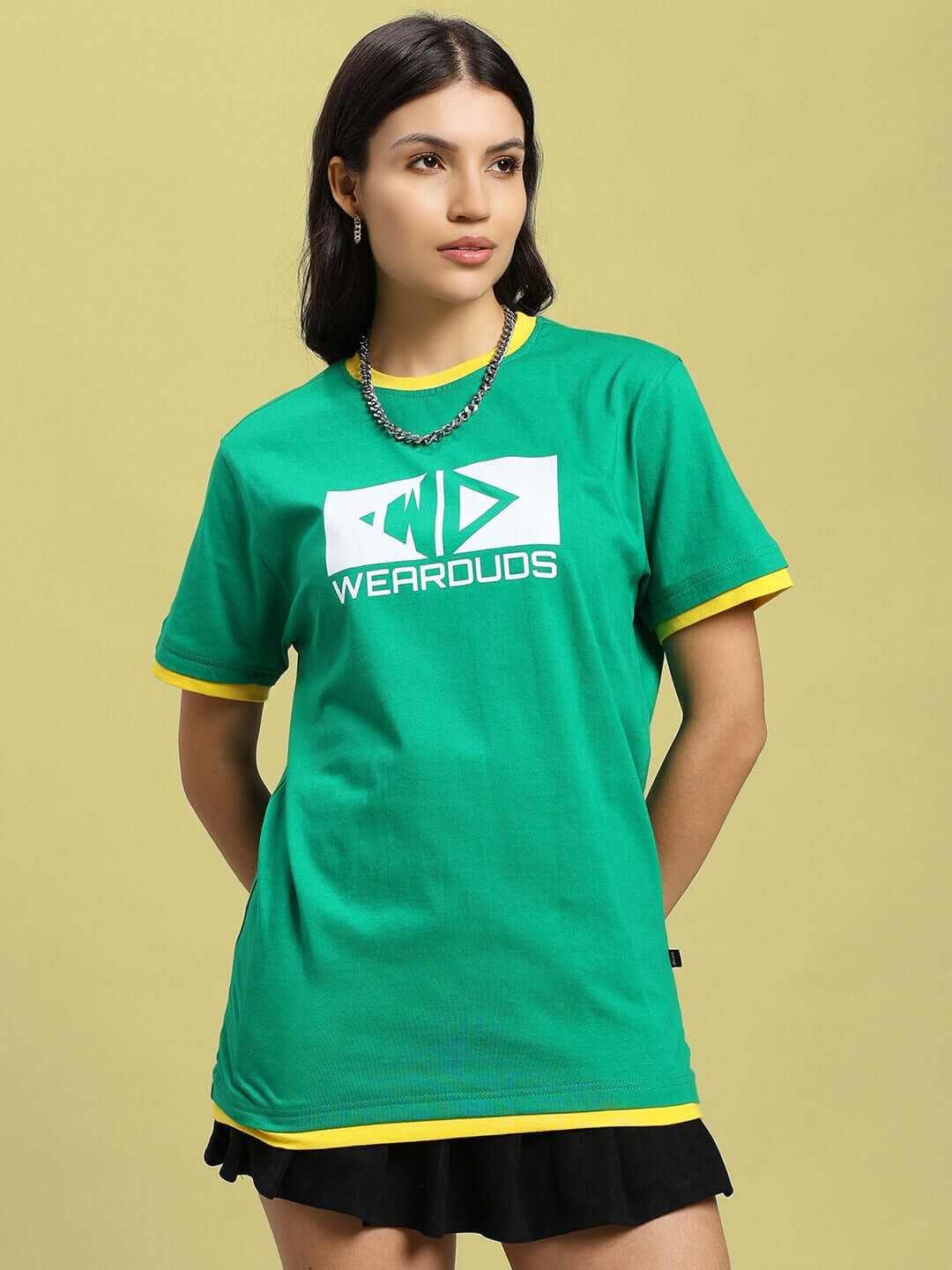 Woman wearing green Elmer regular fit t-shirt with bold logo, made from 100% cotton, perfect for stylish casual wear.