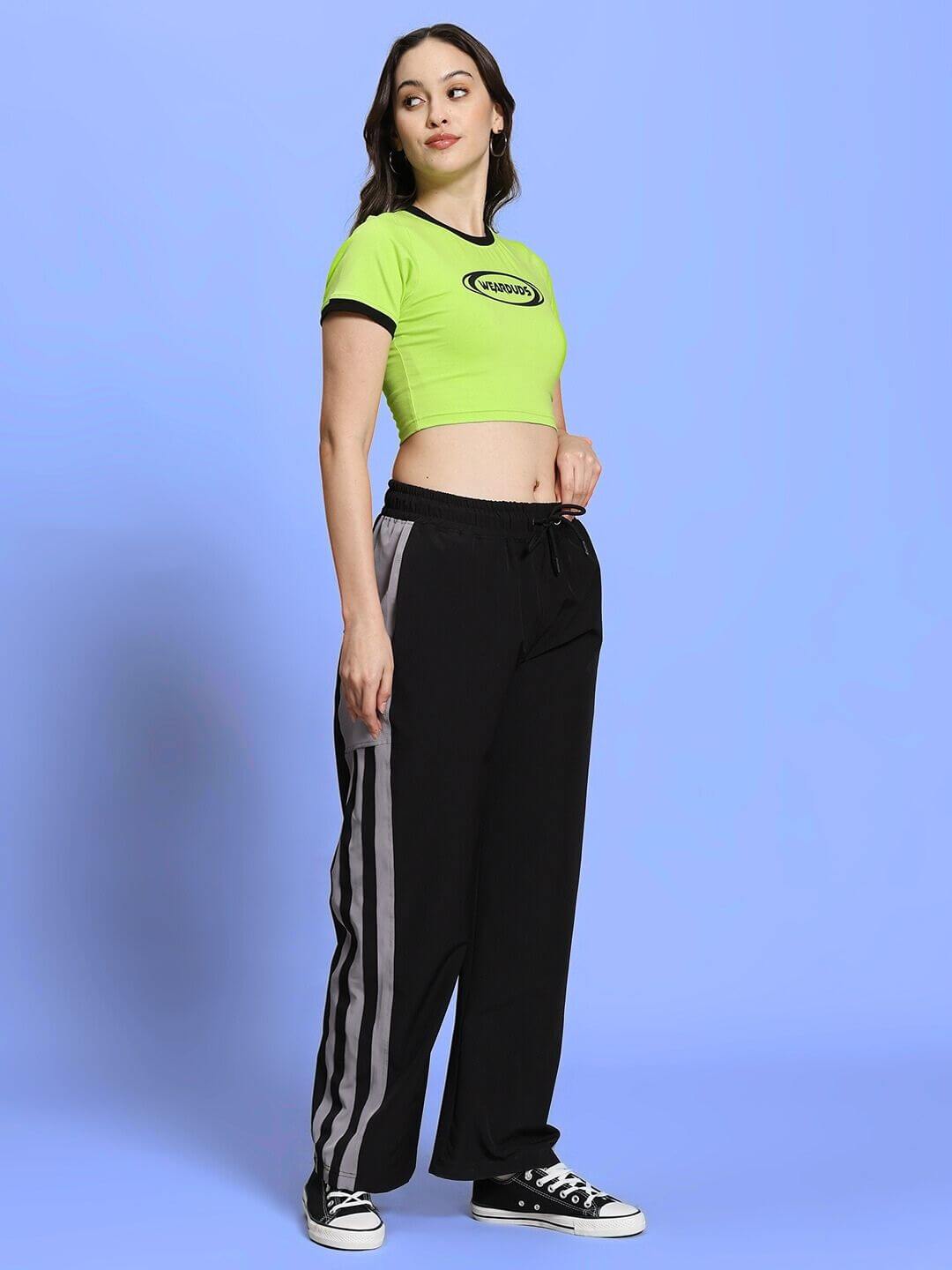 Woman wearing neon green and black co-ord set, relaxed fit joggers with drawstring, comfy and stylish, perfect for casual outings.