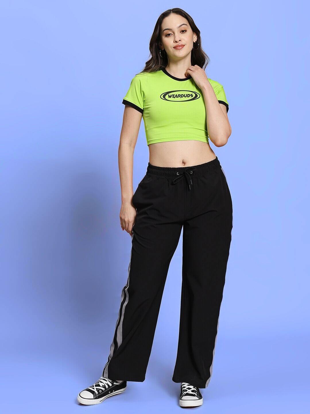 Woman wearing Women's EVA Co-Ord Set in neon green top and black joggers, showcasing a relaxed fit fashion style with drawstring waist.