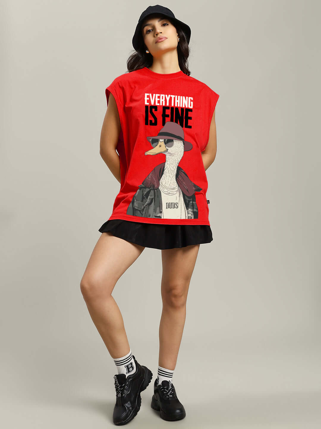 Model wearing red Women's Everything Fine Gym T-Shirt with duck graphic and 'Everything is Fine' text from DUDS collection.