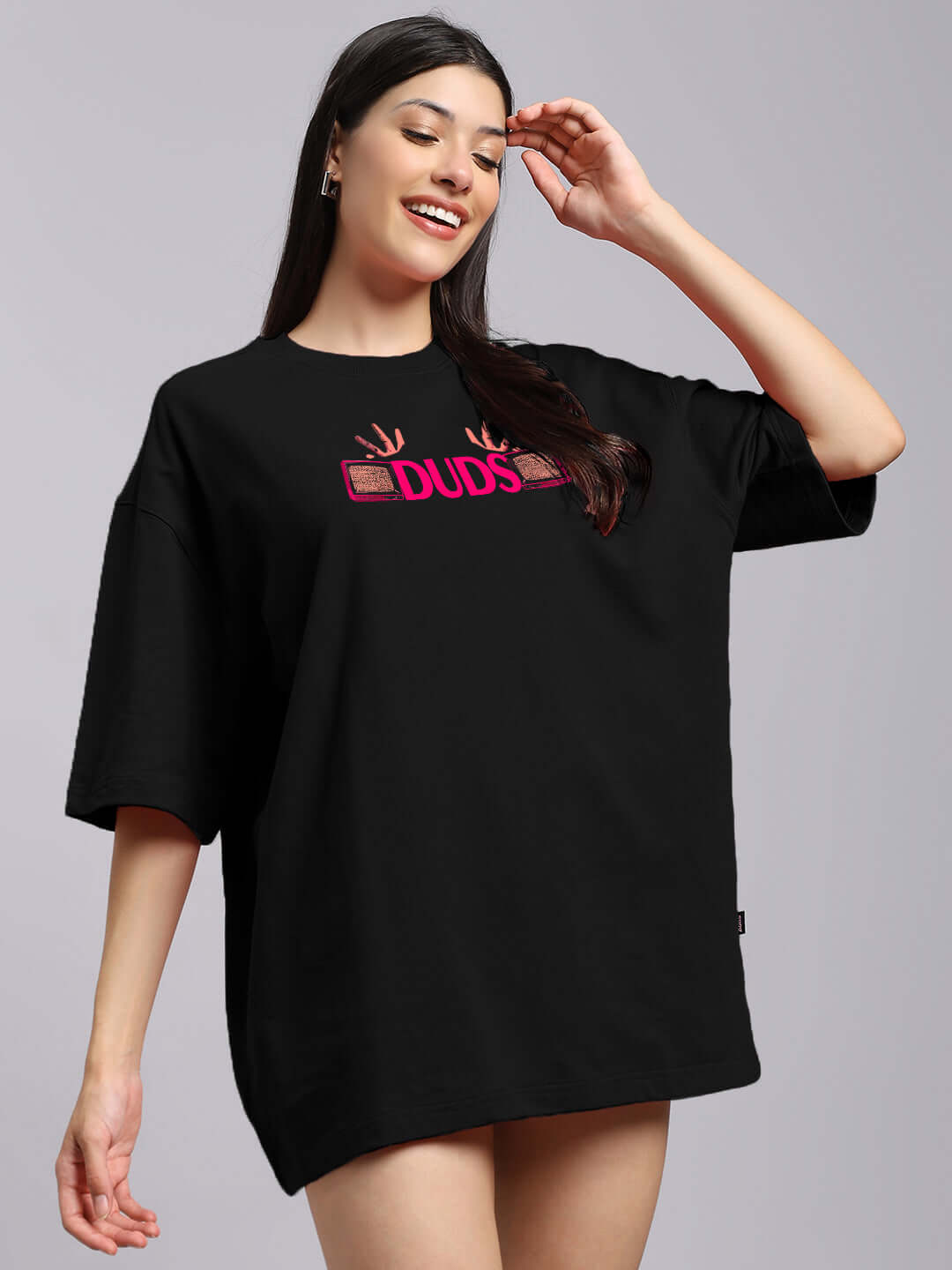 Woman wearing WOMENS EYECONIC OVERSIZED PRINTED T-SHIRT BLACK with graphic print, showcasing streetwear fashion style.
