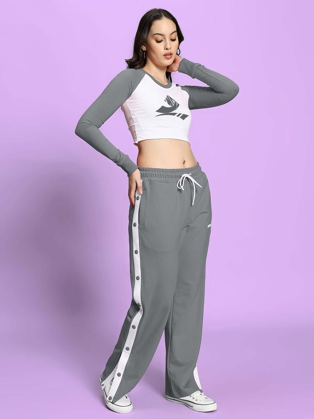Model wearing Women's Ezel Co-Ord Set in grey and white, featuring relaxed fit joggers and elastic waistband. Premium cotton blend.