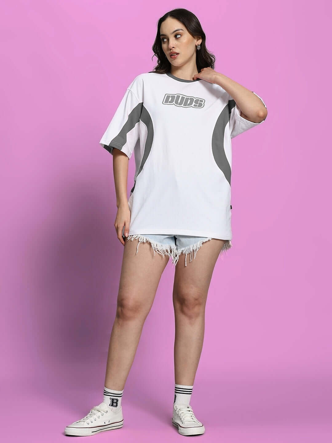 Model wearing Women's Ezel oversized t-shirt in white grey, showcasing premium cotton fabric with sporty design, ideal for casual wear.