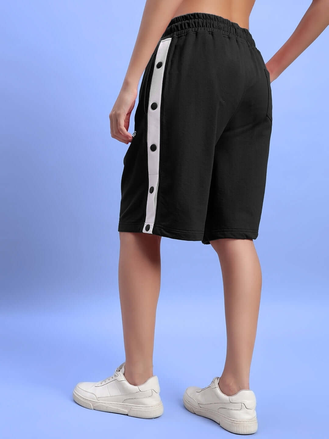 Back view of Women's Ezel Regular Fit Black Shorts with white side stripes, showcasing a relaxed and comfortable fit.