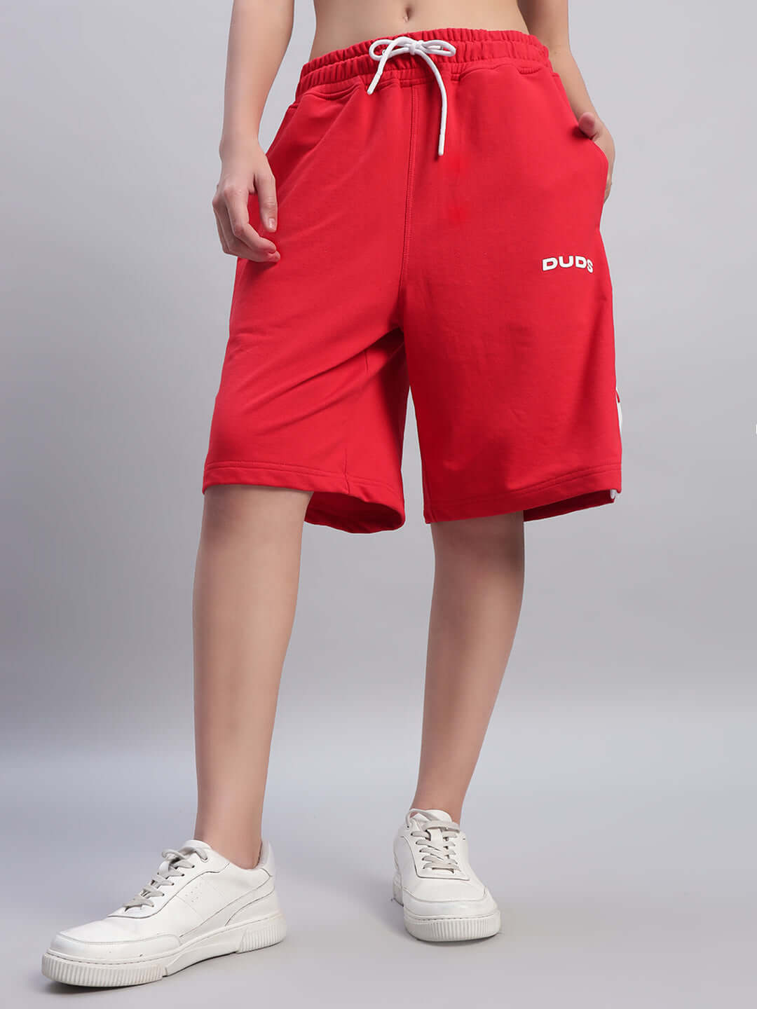 Woman wearing red DUDS EZEL Regular Fit Shorts with drawstring, showcasing comfortable and stylish design suitable for custom fit options.