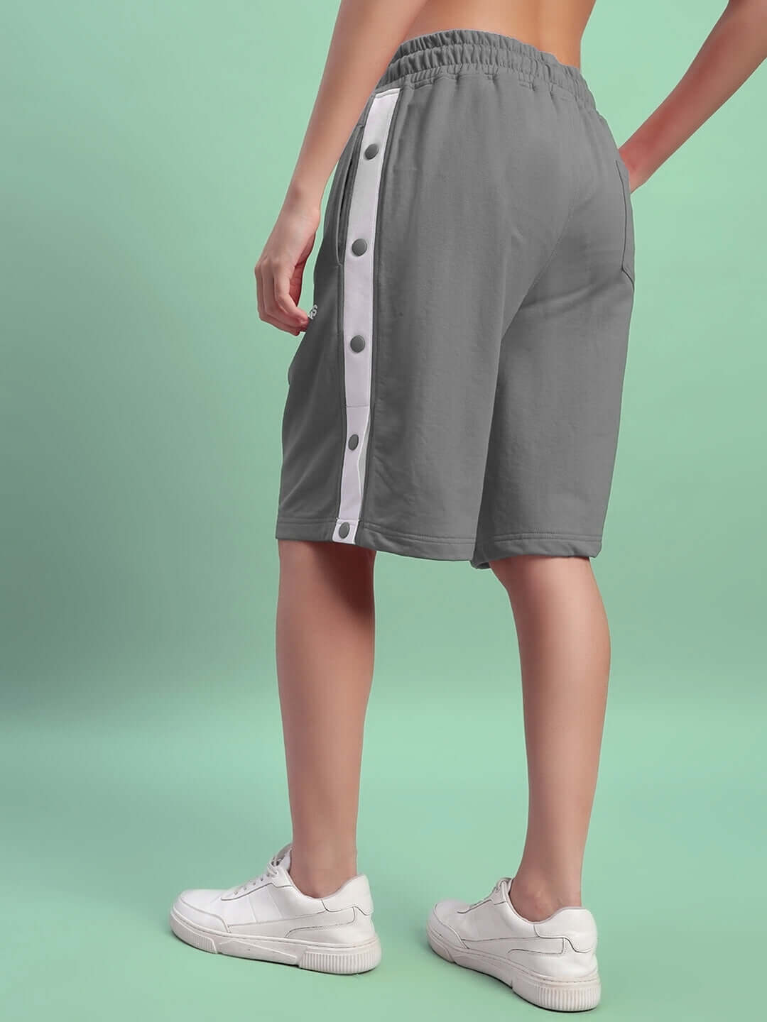 Women's Ezel grey shorts, side view with white stripe and button detail, perfect for custom fit options and versatile fashion.