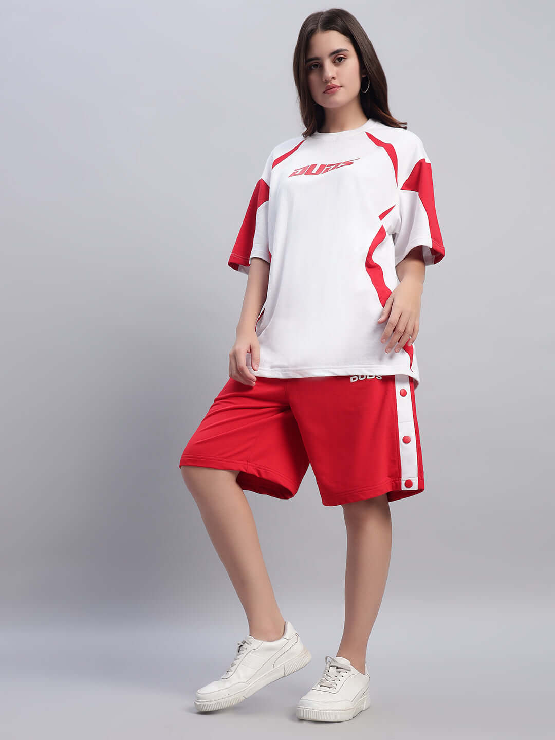 Model wearing Women's Ezel Regular Fit Red Shorts, paired with a white and red shirt, showcasing casual style and comfort.