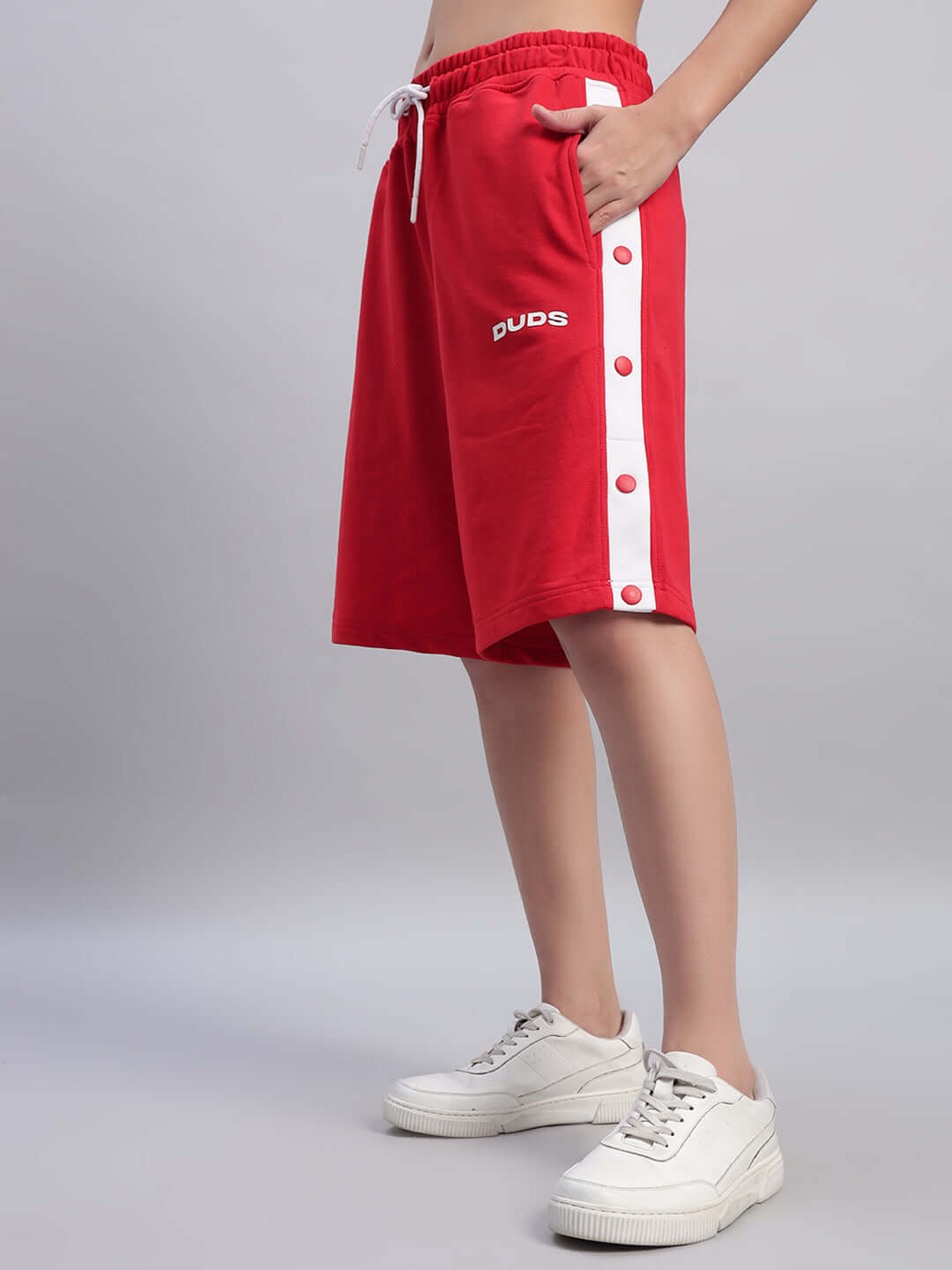 Women's red Ezel regular fit shorts by Duds, featuring side buttons and drawstring waist, offering a comfortable and customizable fit.