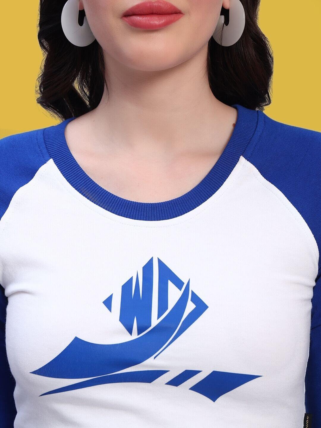Close-up of a woman wearing a Women's Ezel Solid Regular Sleeves Top in white and royal blue with a geometric print.
