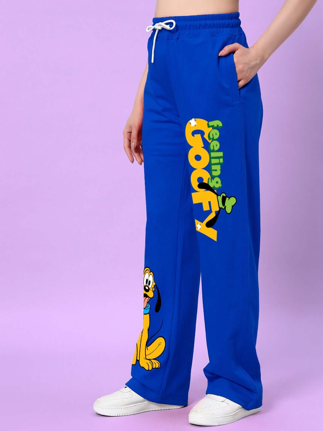 Women's blue relaxed fit jogger with 'Feeling Goofy' print, featuring cartoon design, displayed on model against a purple background.
