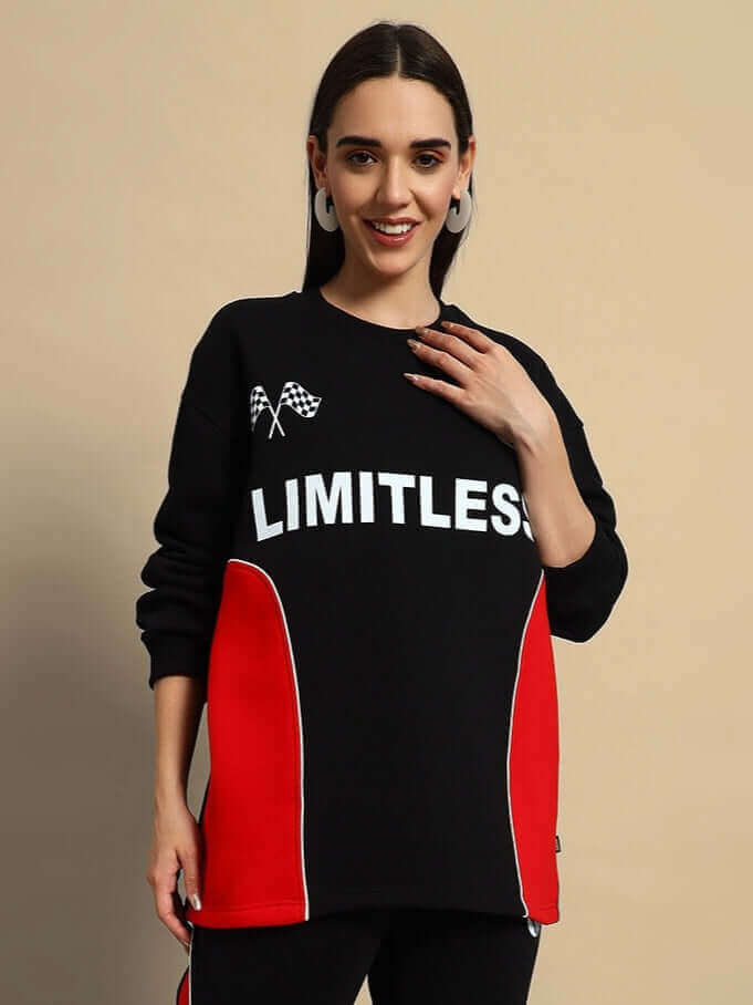 Woman wearing WOMEN'S WD FIREBALL COLORBLOCK CO-ORD in black-red with "LIMITLESS" text, showcasing streetwear style.