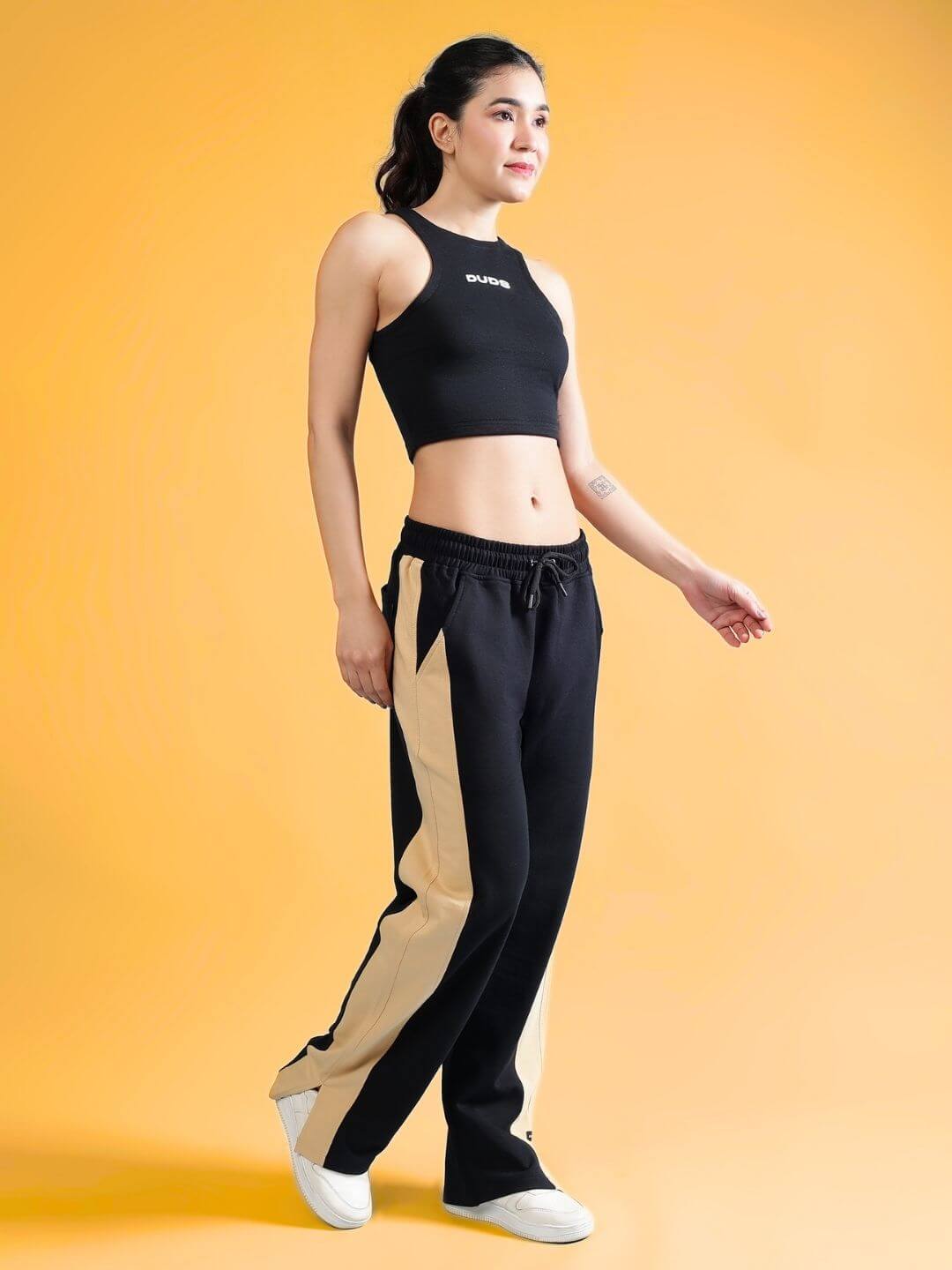 Woman wearing WOMEN'S FITFINITY CO-ORD SET BLACK with joggers and crop top, stylish and comfortable fit, premium cotton fabric.