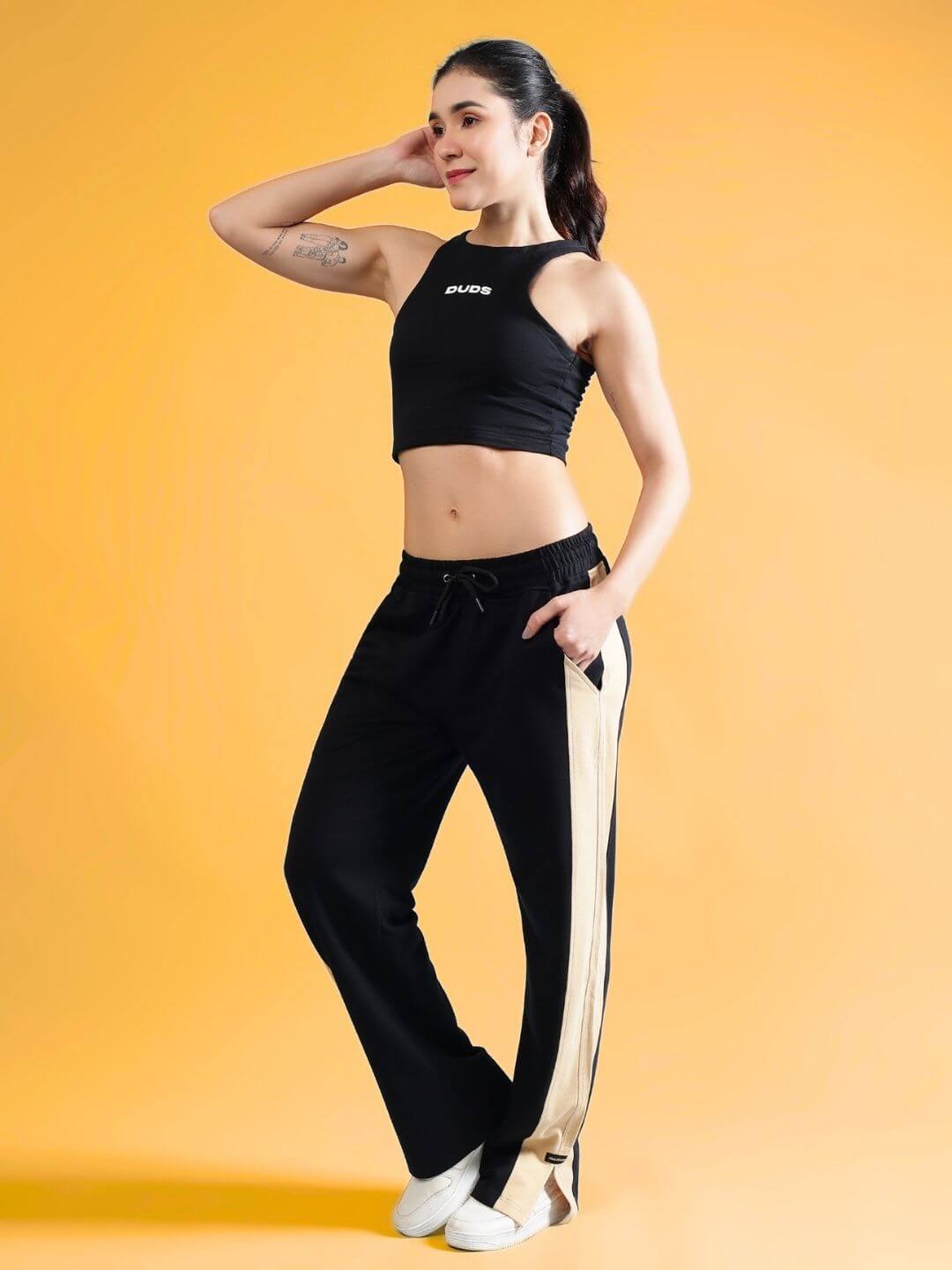 Woman wearing WOMEN'S FITFINITY CO-ORD SET BLACK, showcasing relaxed fit joggers with drawstring waistband and premium cotton fabric.