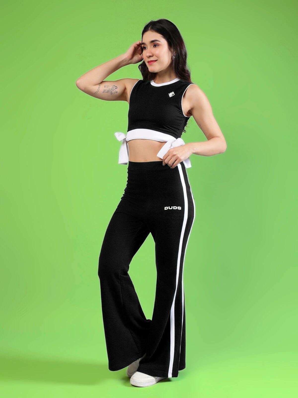WOMENS FITTONIA COOL CO-ORD SET BLACK worn by a model on a green background, showcasing trendy black matching outfit.
