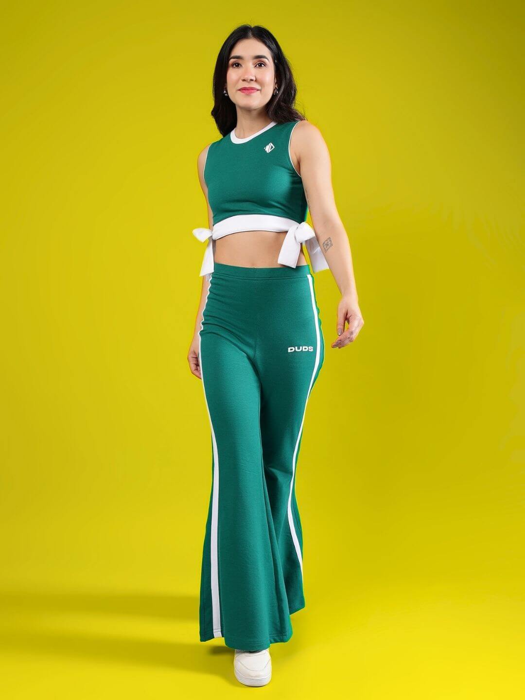 Woman modeling Women's Fittonia Cool Co-Ord Set in teal green with relaxed fit joggers and top, yellow background.