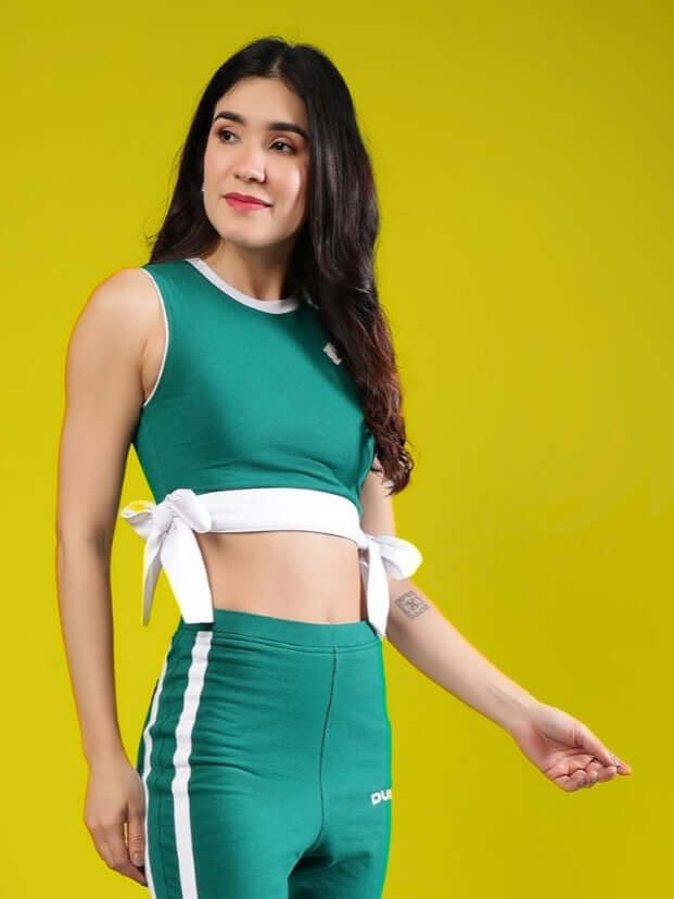 Woman wearing teal green crop top with side ties, part of Women's Fittonia collection, crafted from premium cotton French Terry Lycra. Fashionable and comfortable activewear.