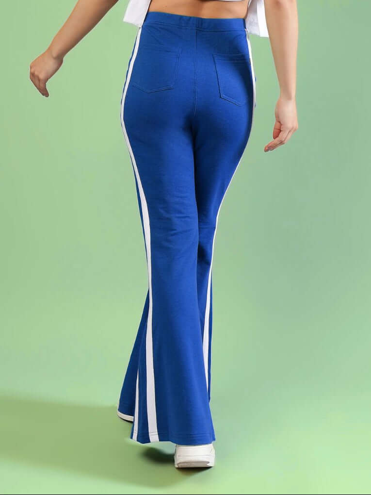WOMENS FITTONIA COOL WIDE FLARE JOGGERS BLUE shown from the back, featuring a relaxed fit and stylish wide-flare silhouette.