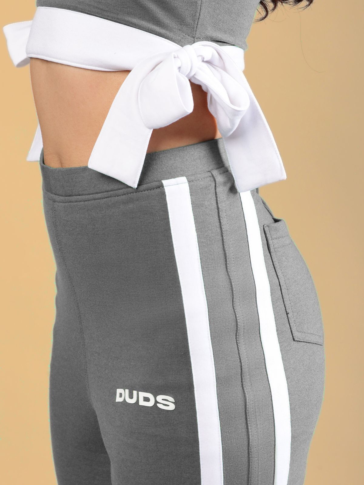 WOMENS FITTONIA COOL WIDE FLARE JOGGERS GERY showcasing a trendy grey design with white side stripes for stylish comfort.