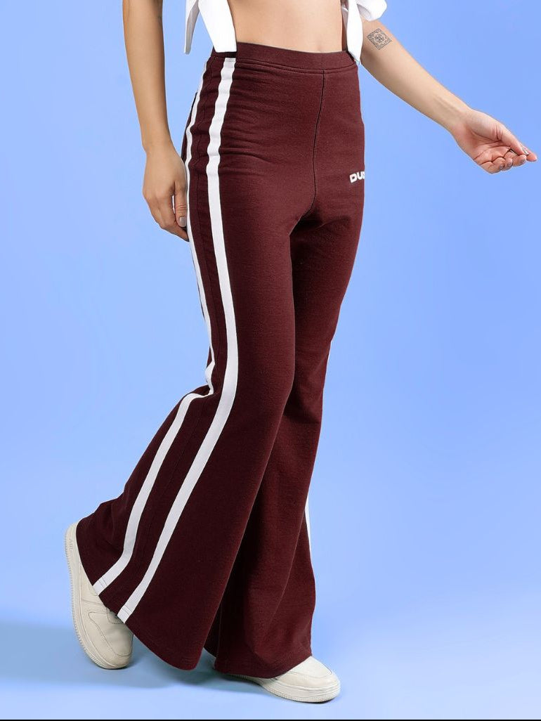 WOMENS FITTONIA COOL WIDE FLARE JOGGERS MAROON model showcasing stylish fit with white stripes and relaxed design.