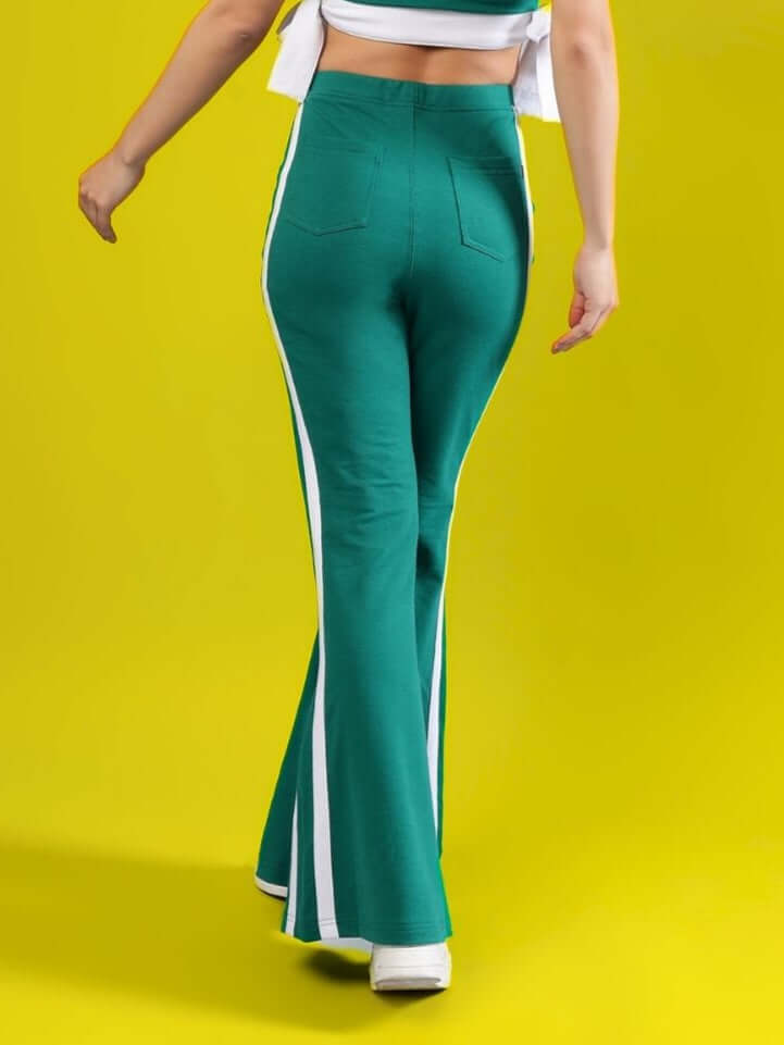 Model wearing Women's Fittonia Cool Wide Flare Joggers in teal green with white stripes, featuring a high waist and comfortable fit, by DUDS.